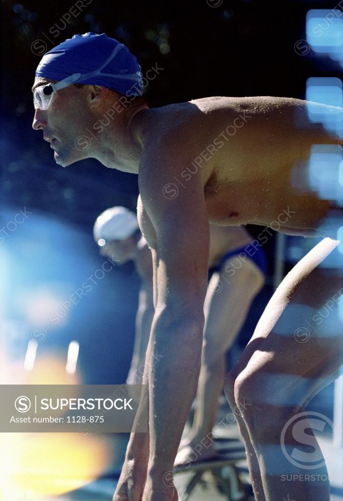 Stock Photo: 1128-875 Side profile of two swimmers in the starting position