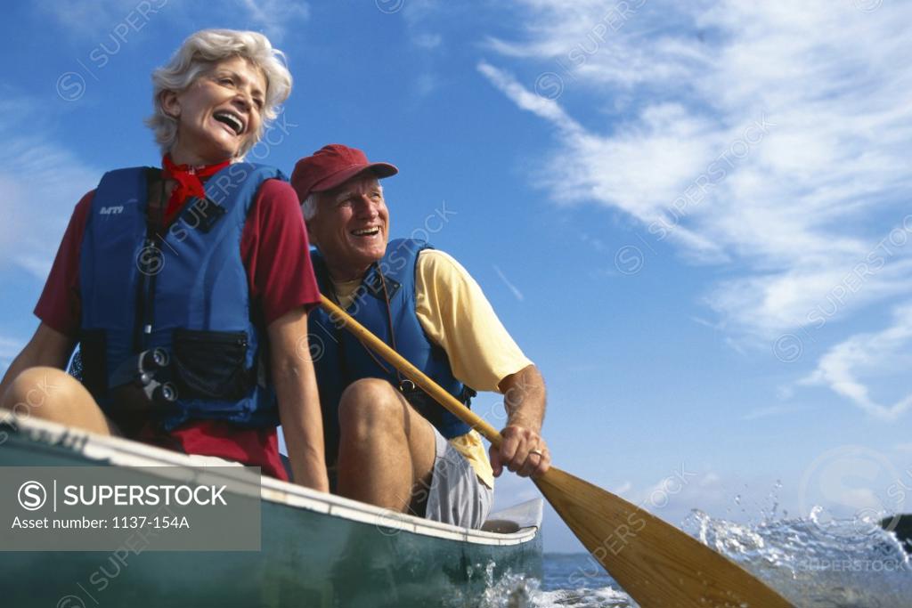 Stock Photo: 1137-154A Senior couple in a row boat
