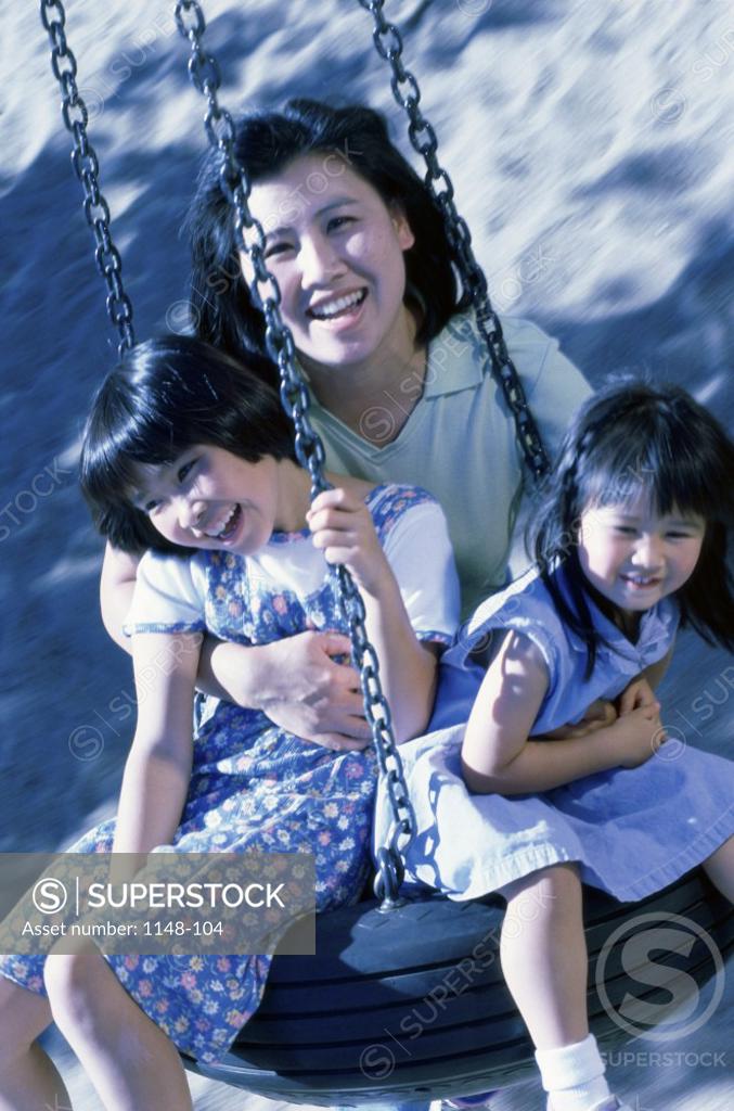 Stock Photo: 1148-104 Portrait of a mother sitting on a tire swing with her son and daughter