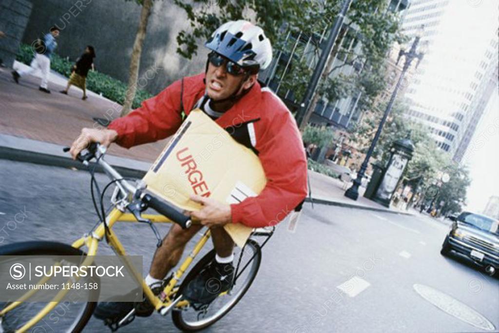 Stock Photo: 1148-158 Bicycle messenger delivering a package