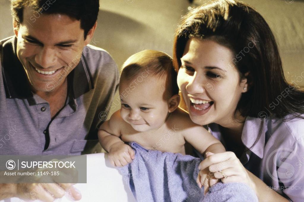 Stock Photo: 1149-185 Parents smiling with their baby boy