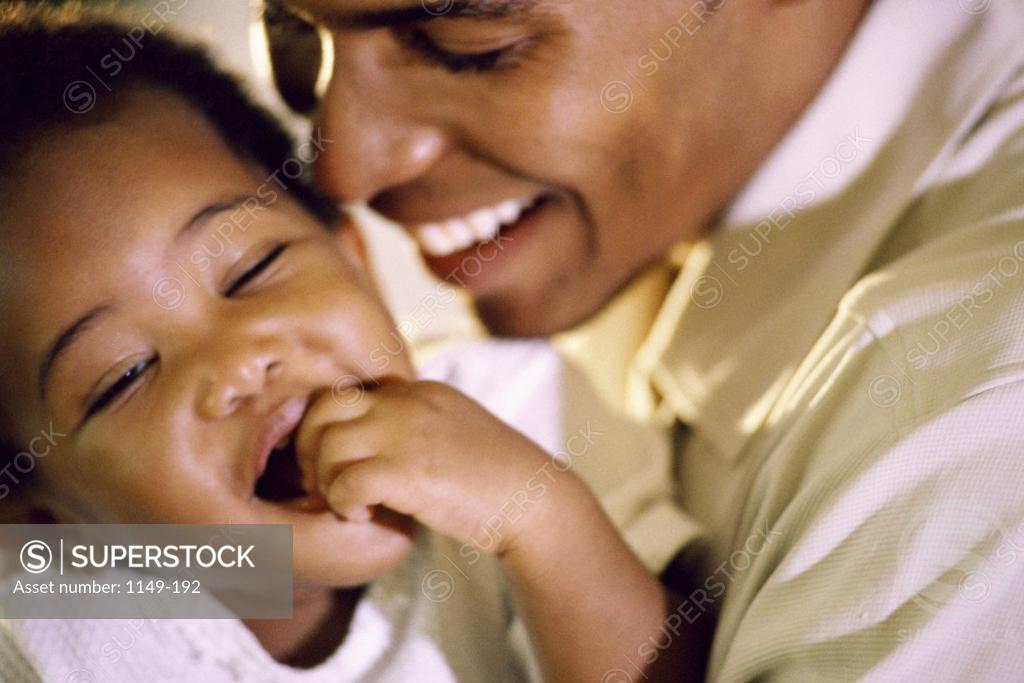 Stock Photo: 1149-192 Close-up of a father playing with his baby girl