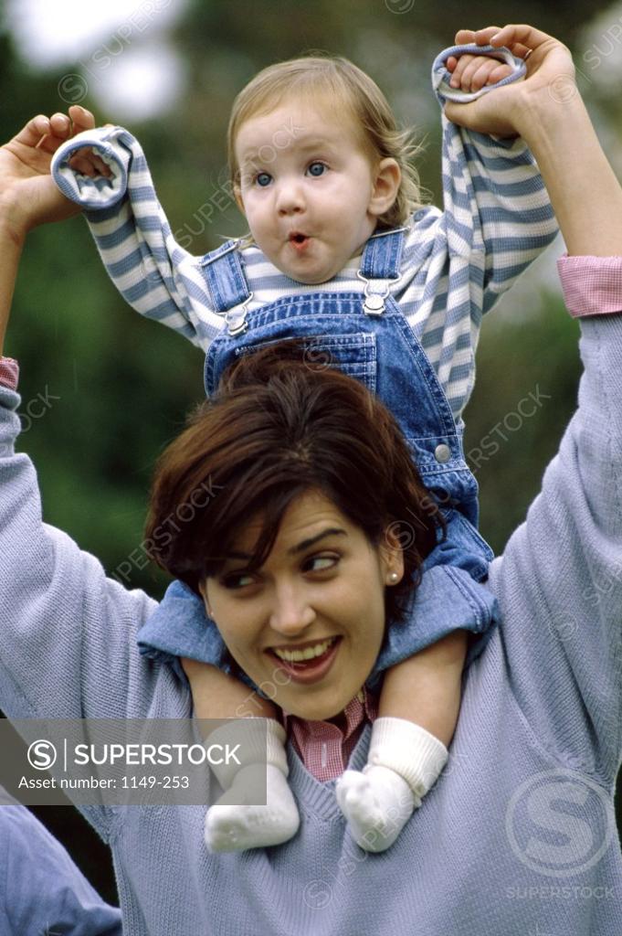 Stock Photo: 1149-253 Mother carrying her son on her shoulders