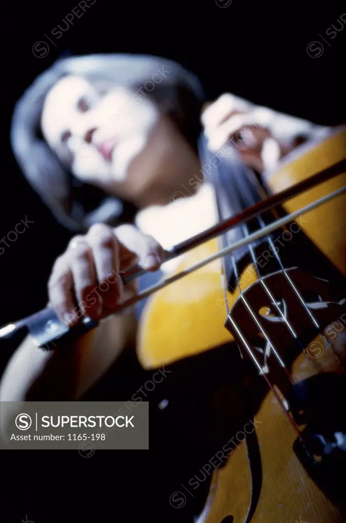 Low angle view of a young woman playing the cello
