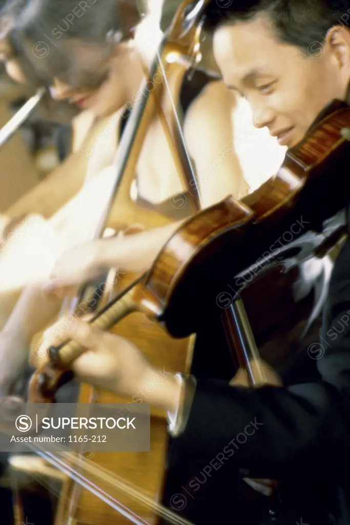 Side profile of a young man playing the violin