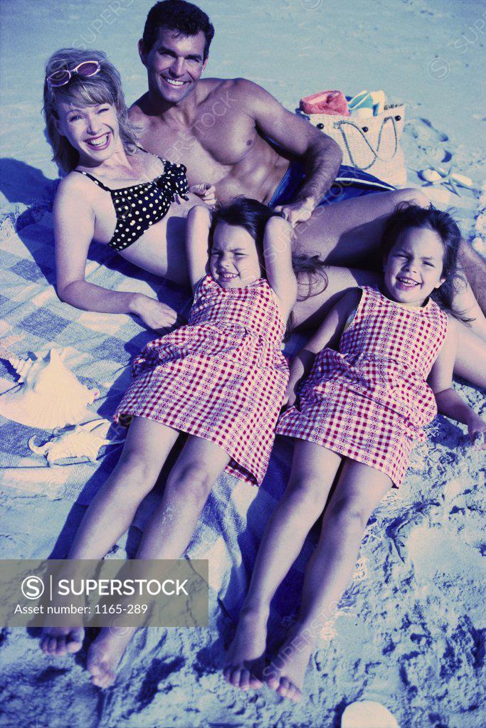 Stock Photo: 1165-289 Portrait of a young couple on the beach with their two daughters