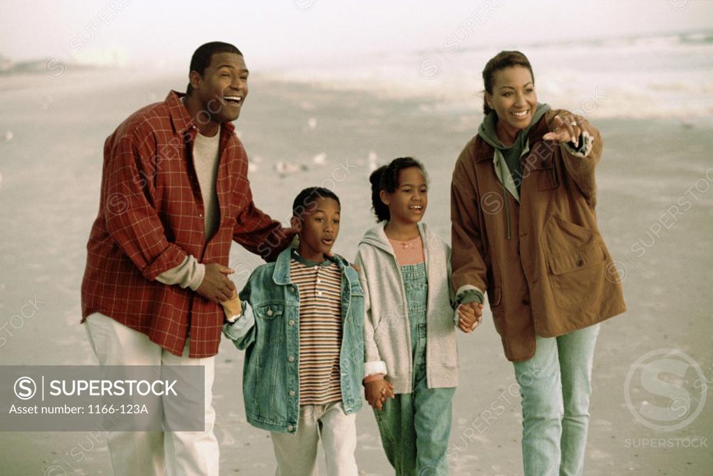 Stock Photo: 1166-123A Young couple on the beach with their son and daughter