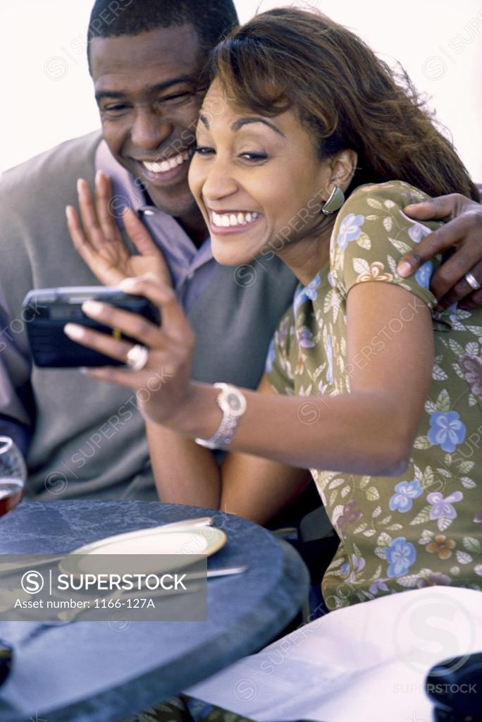 Stock Photo: 1166-127A Young couple taking a photograph of themselves