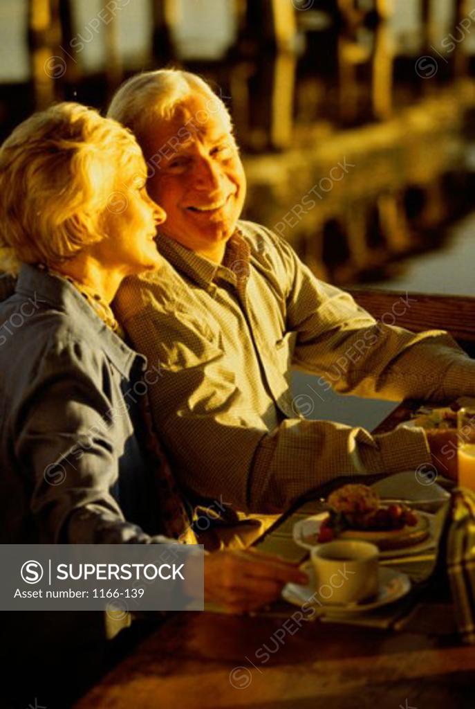 Stock Photo: 1166-139 Side profile of a senior couple sitting in a restaurant