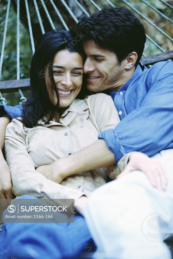 Stock Photo: 1166-166 Young couple lying in a hammock
