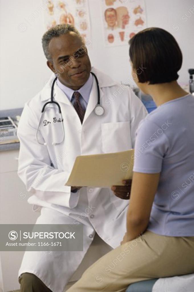 Stock Photo: 1166-1671 Male doctor talking to a female patient