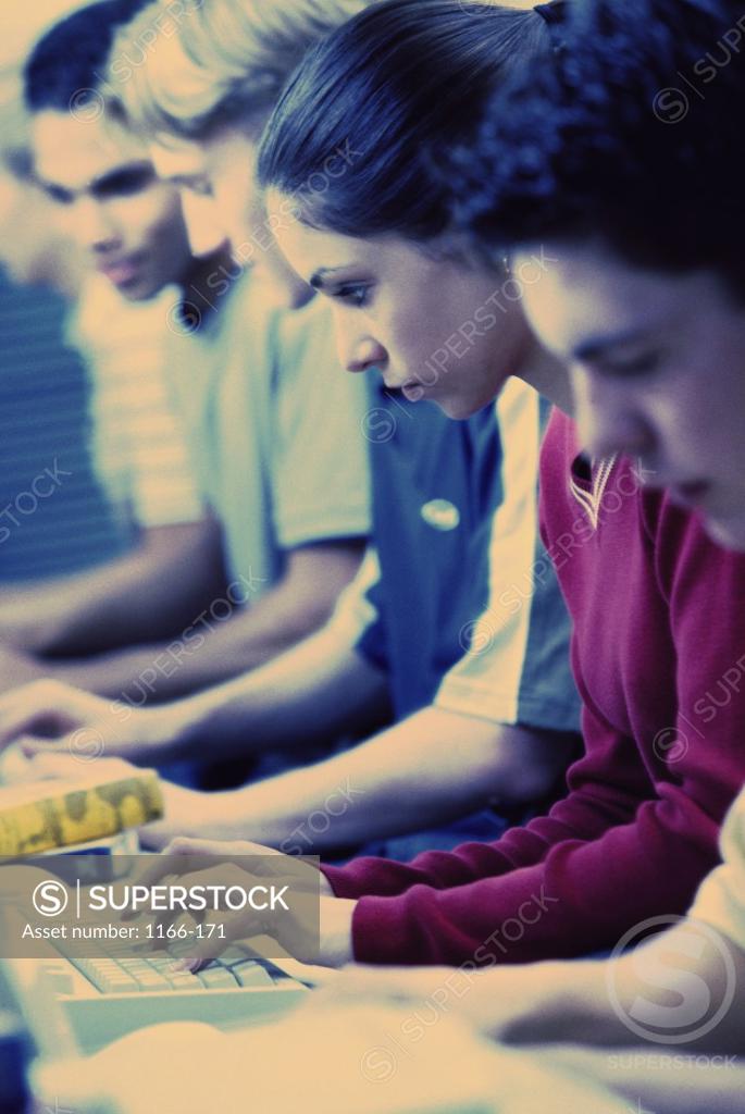 Stock Photo: 1166-171 Students sitting in a row in front of computers