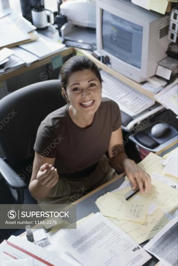 Stock Photo: 1166-2278 Portrait of a businesswoman seated behind a desk in an office