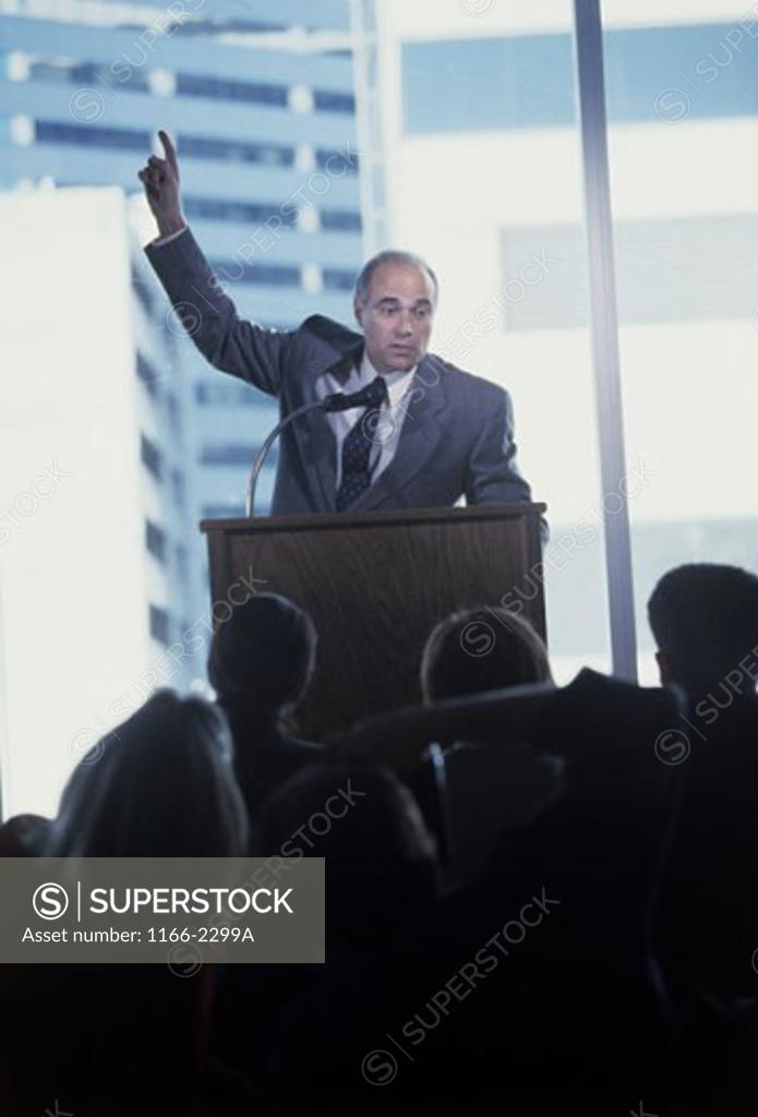 Stock Photo: 1166-2299A Businessman giving a speech at a podium