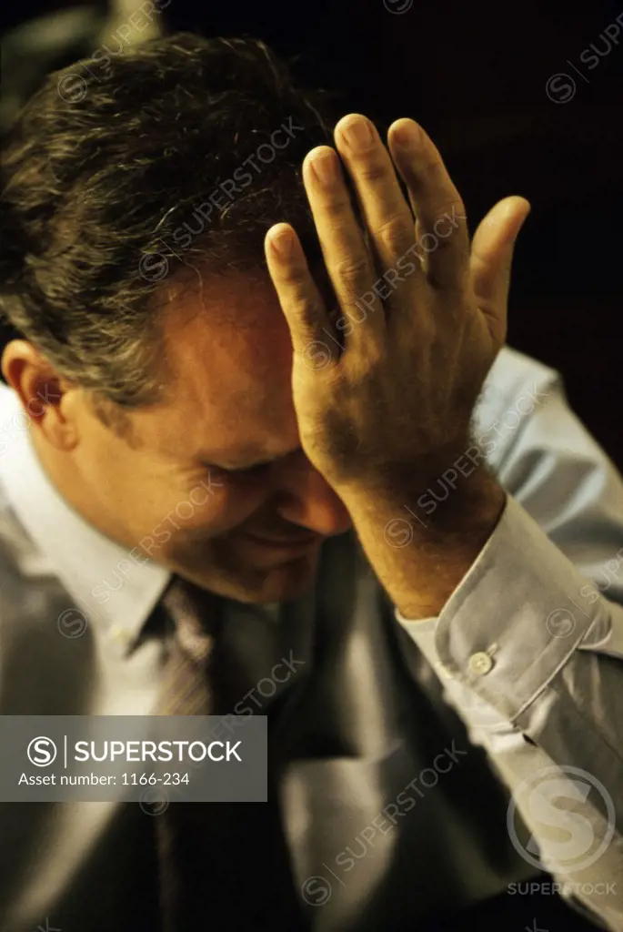 Businessman with his hand on his head