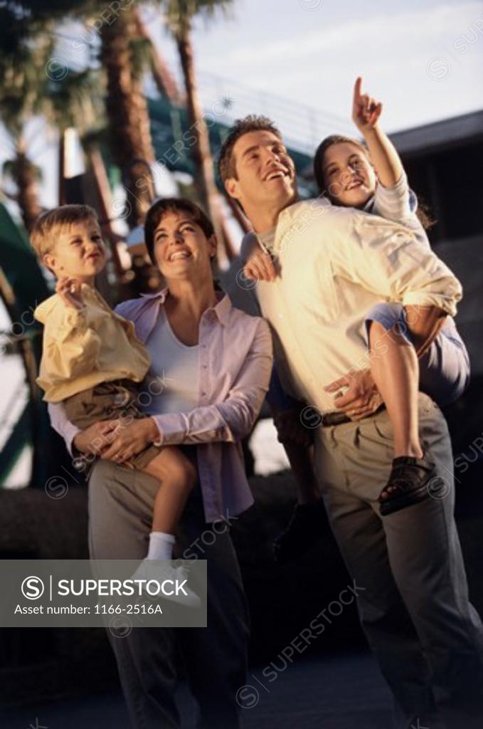 Stock Photo: 1166-2516A Parents carrying their son and daughter