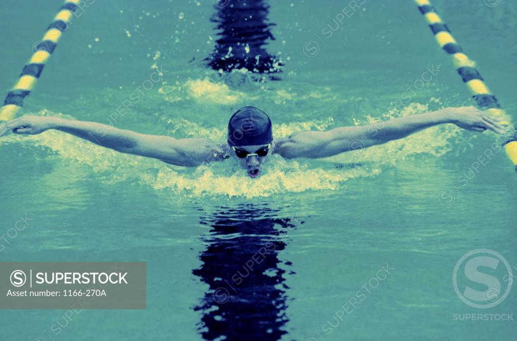 Stock Photo: 1166-270A Young man swimming the butterfly stroke
