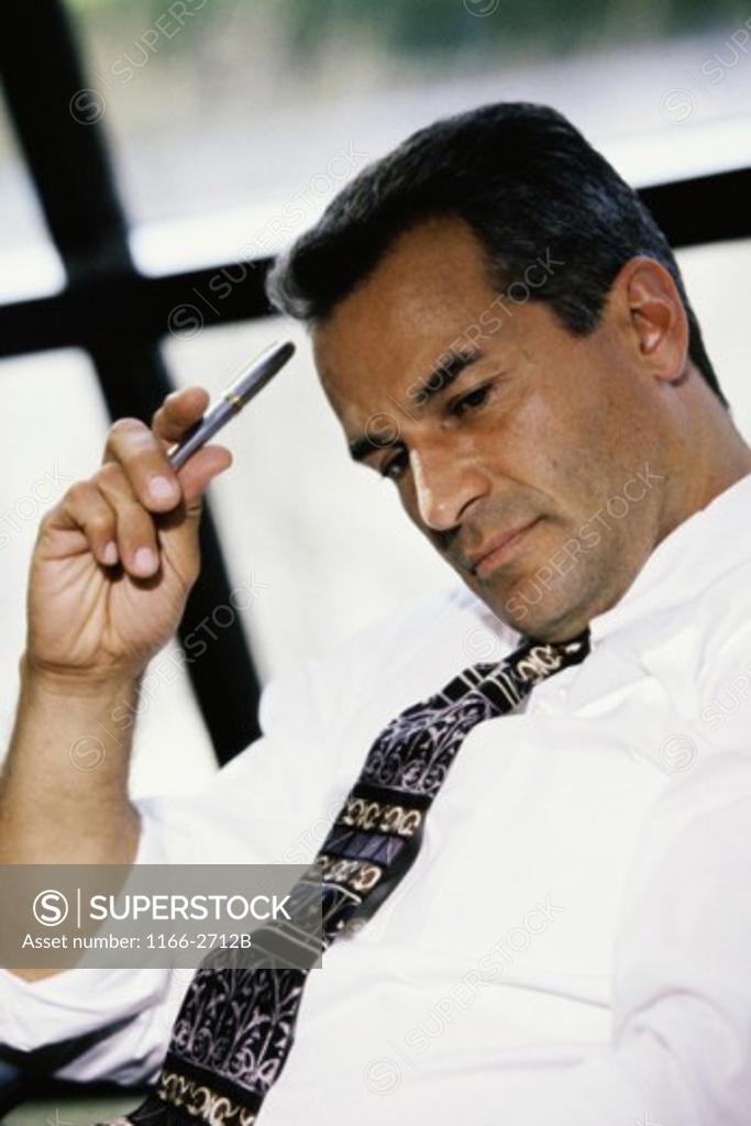 Stock Photo: 1166-2712B Side profile of a businessman thinking
