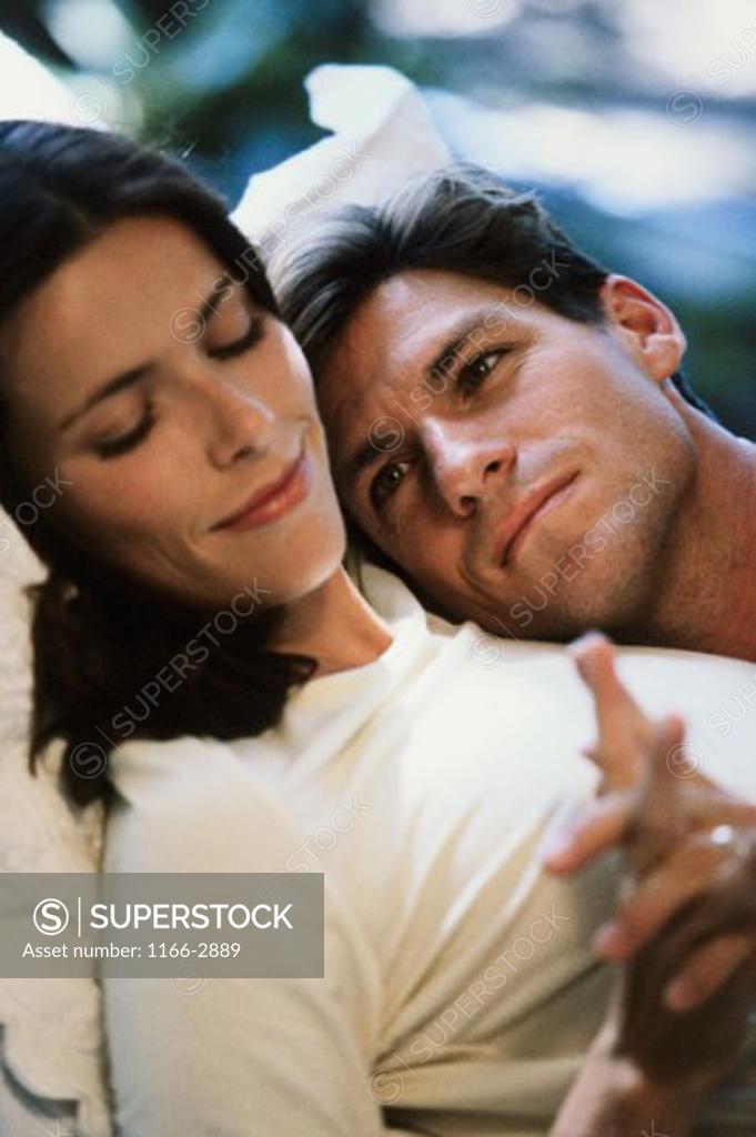 Stock Photo: 1166-2889 Close-up of a young couple lying on the bed