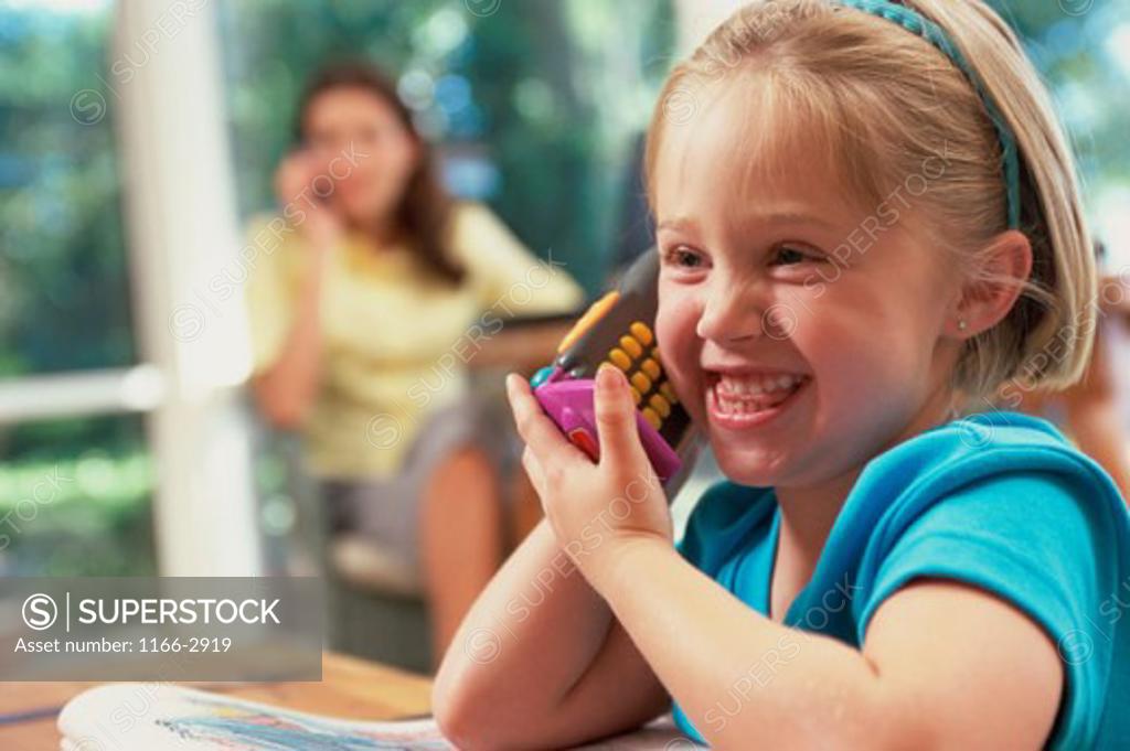 Stock Photo: 1166-2919 Close-up of a girl talking on a toy phone