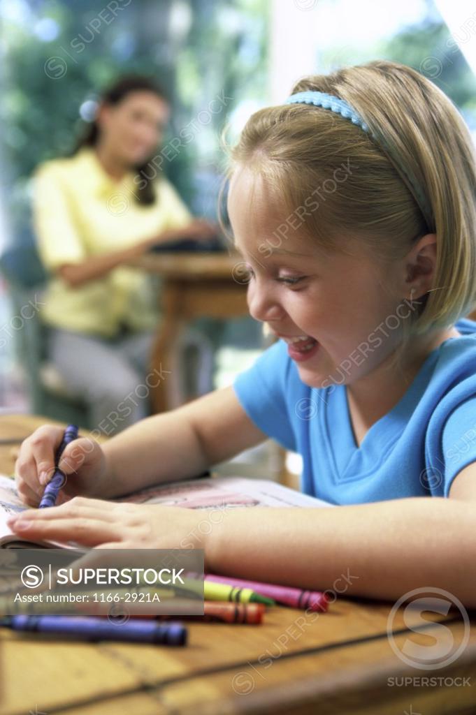 Stock Photo: 1166-2921A Close-up of a girl drawing with crayons