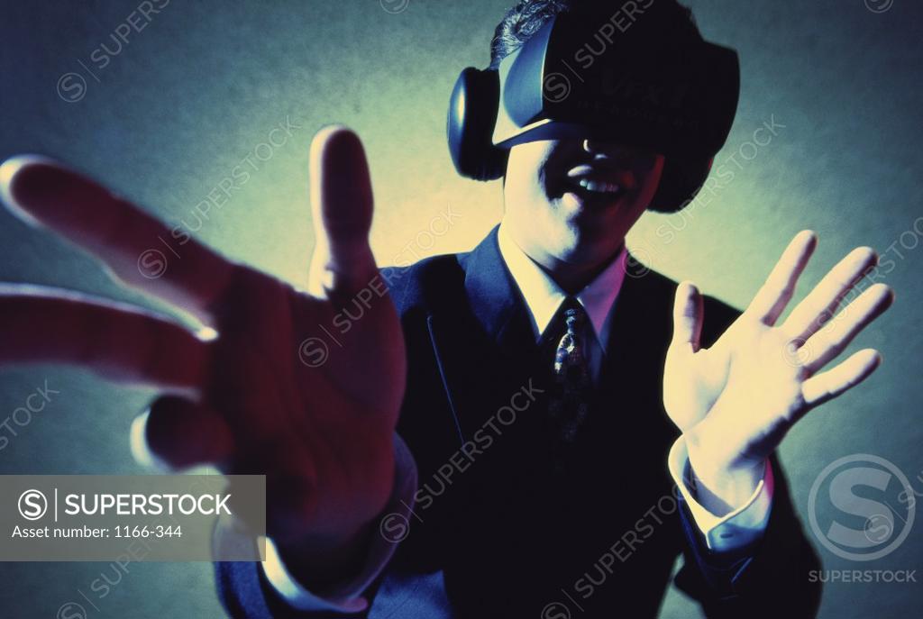 Stock Photo: 1166-344 Businessman wearing virtual reality goggles