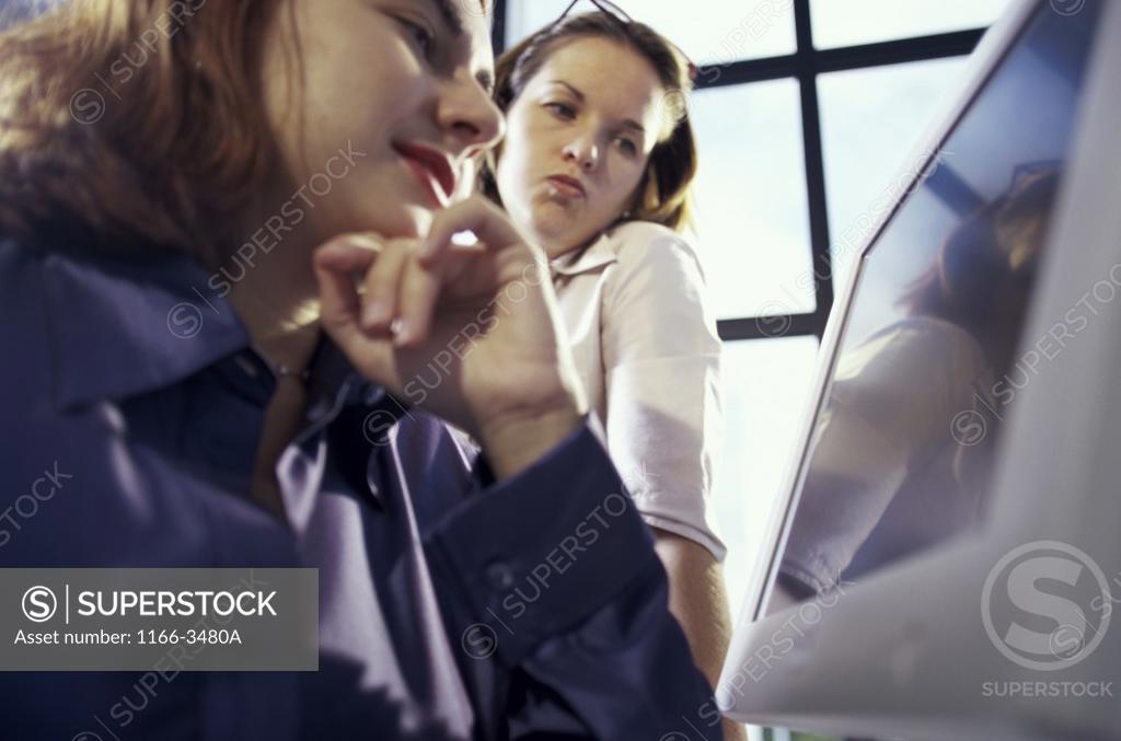 Stock Photo: 1166-3480A Two businesswomen using a computer