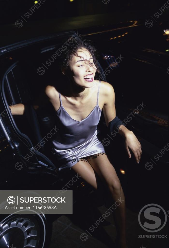 Stock Photo: 1166-3553A High angle view of a young woman exiting a car