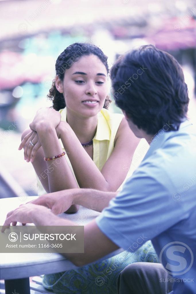 Stock Photo: 1166-3605 Young man and a teenage girl talking