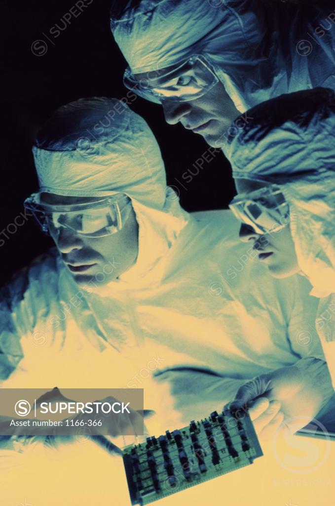 Stock Photo: 1166-366 Three researchers in protective clothing