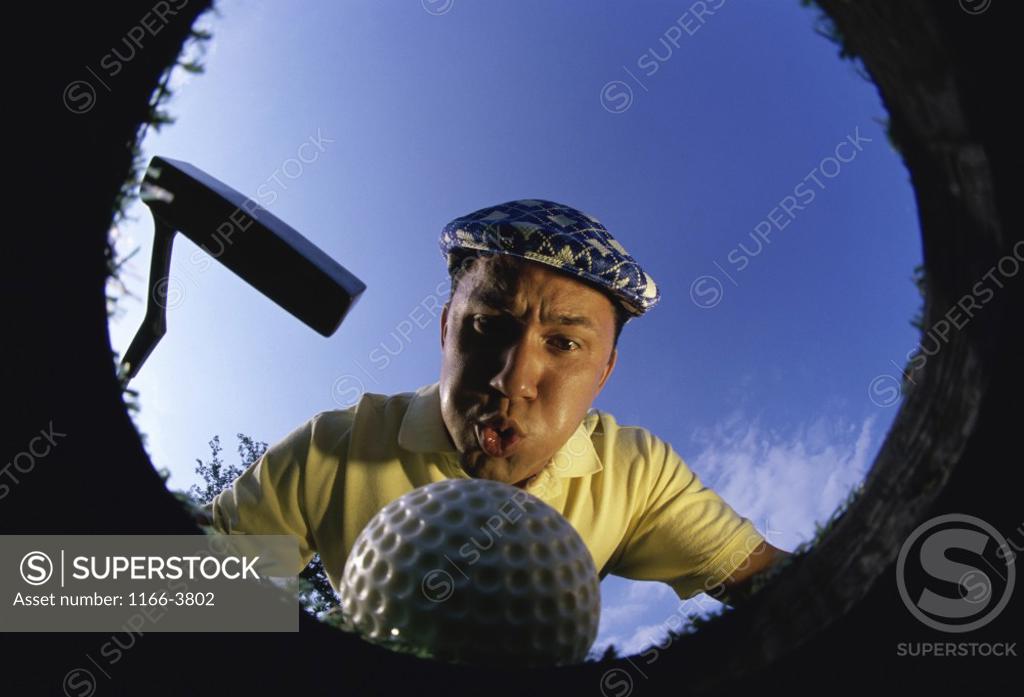 Stock Photo: 1166-3802 Low angle view of a golf ball falling into a cup
