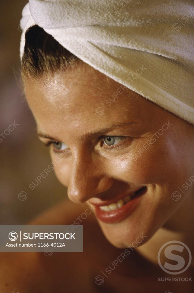 Stock Photo: 1166-4012A Close-up of a young woman with a towel wrapped around her head