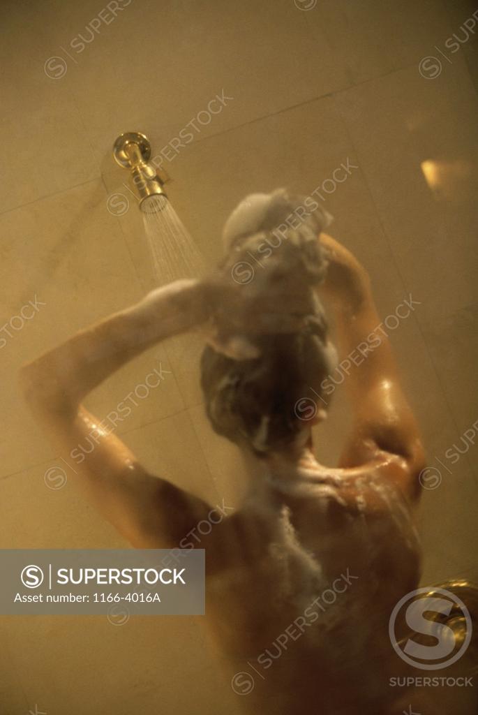 Stock Photo: 1166-4016A Rear view of a young woman shampooing her hair