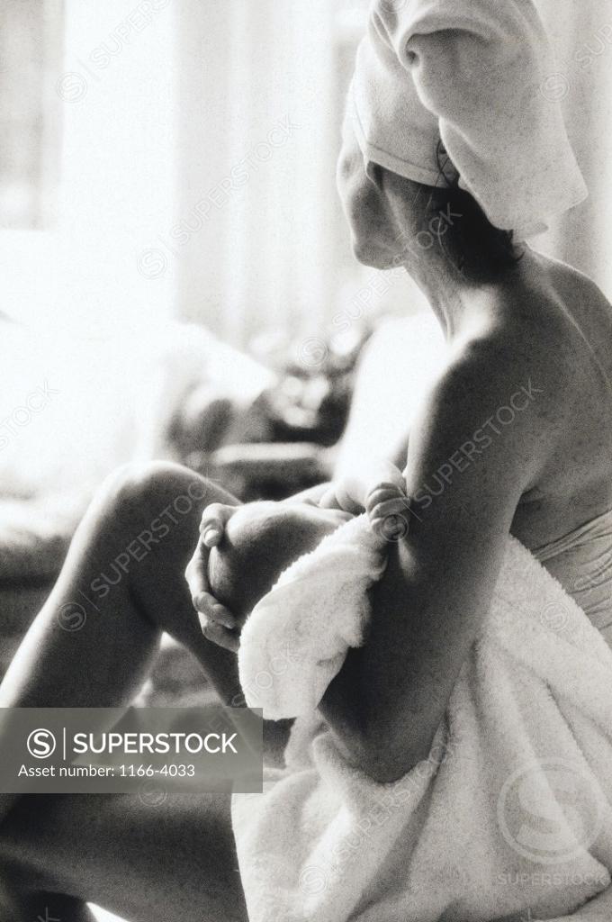 Stock Photo: 1166-4033 Side profile of a mother breastfeeding her baby girl