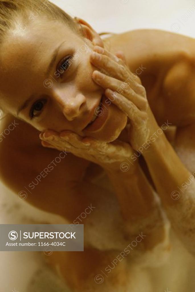 Stock Photo: 1166-4034C Portrait of a young woman taking a bath