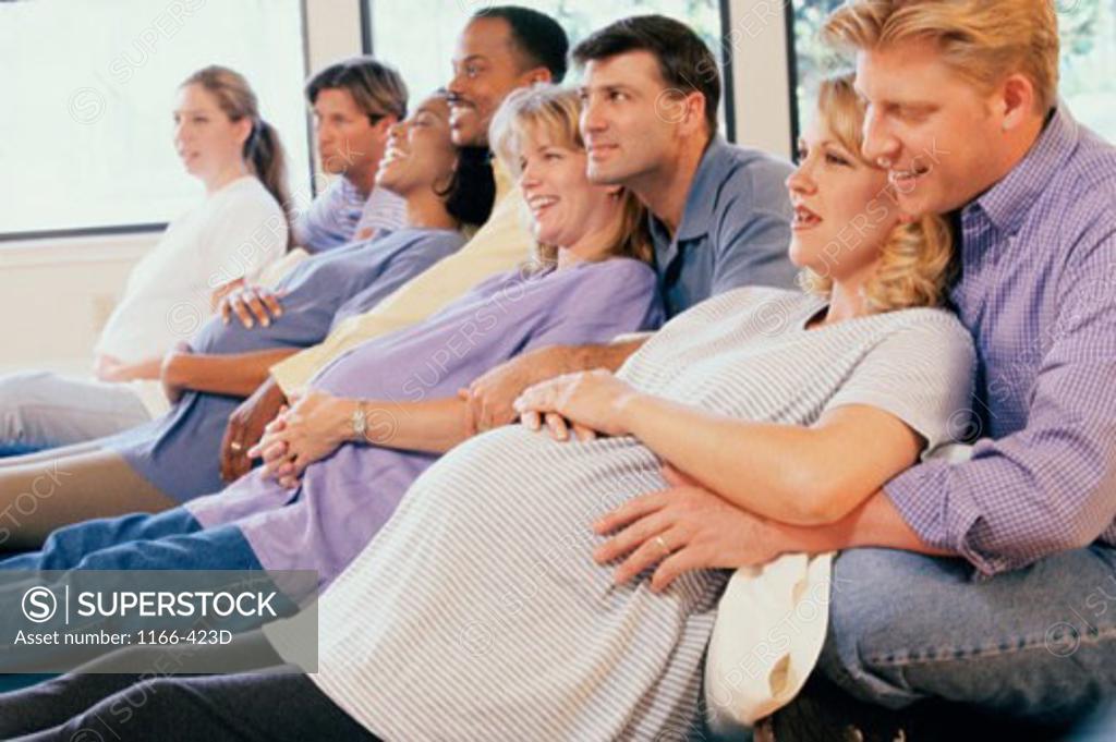 Stock Photo: 1166-423D Husbands and their pregnant wives at a prenatal class