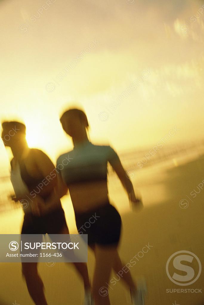 Stock Photo: 1166-436 Couple running on the beach