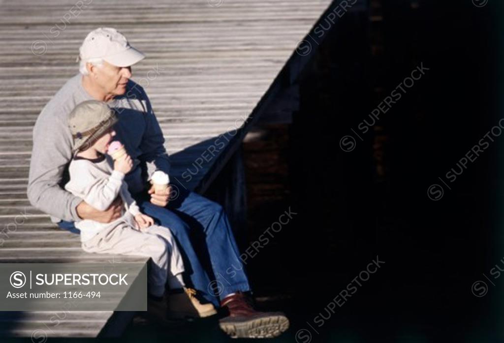 Stock Photo: 1166-494 Grandfather sitting with his grandson