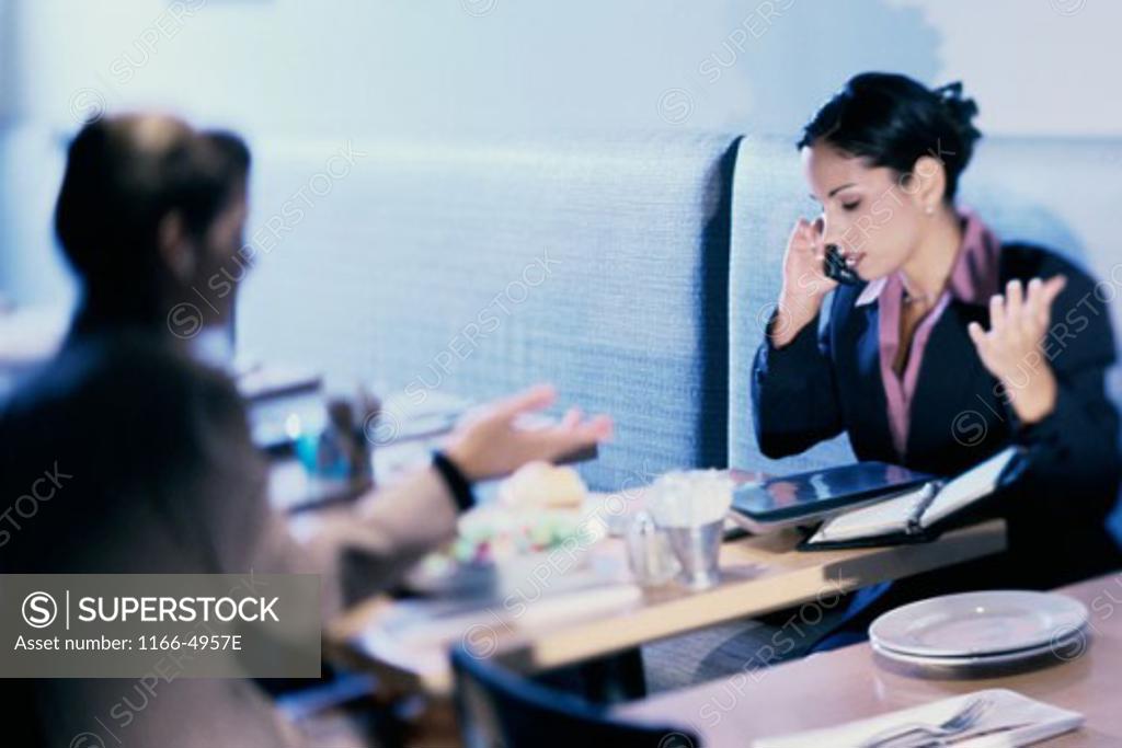 Stock Photo: 1166-4957E Two businesswomen in a cafe