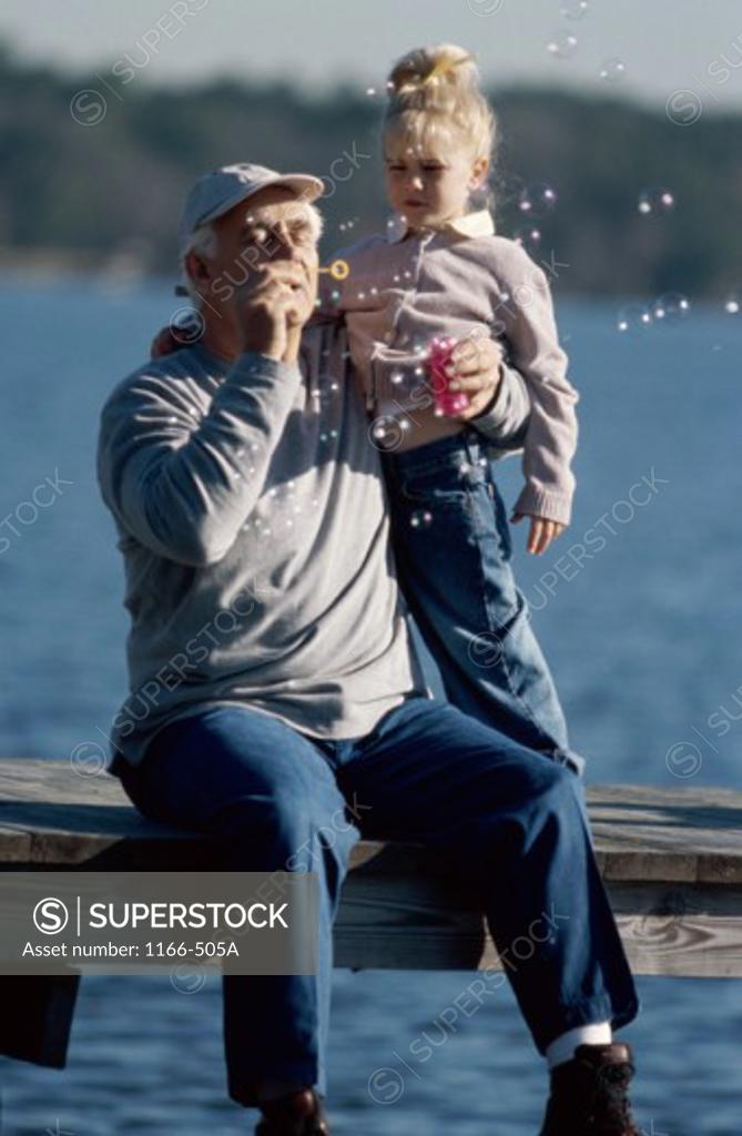 Stock Photo: 1166-505A Grandfather playing with his granddaughter