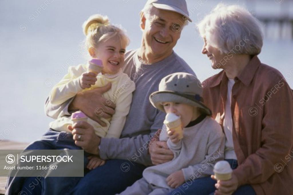 Stock Photo: 1166-507 Grandparents holding their grandchildren