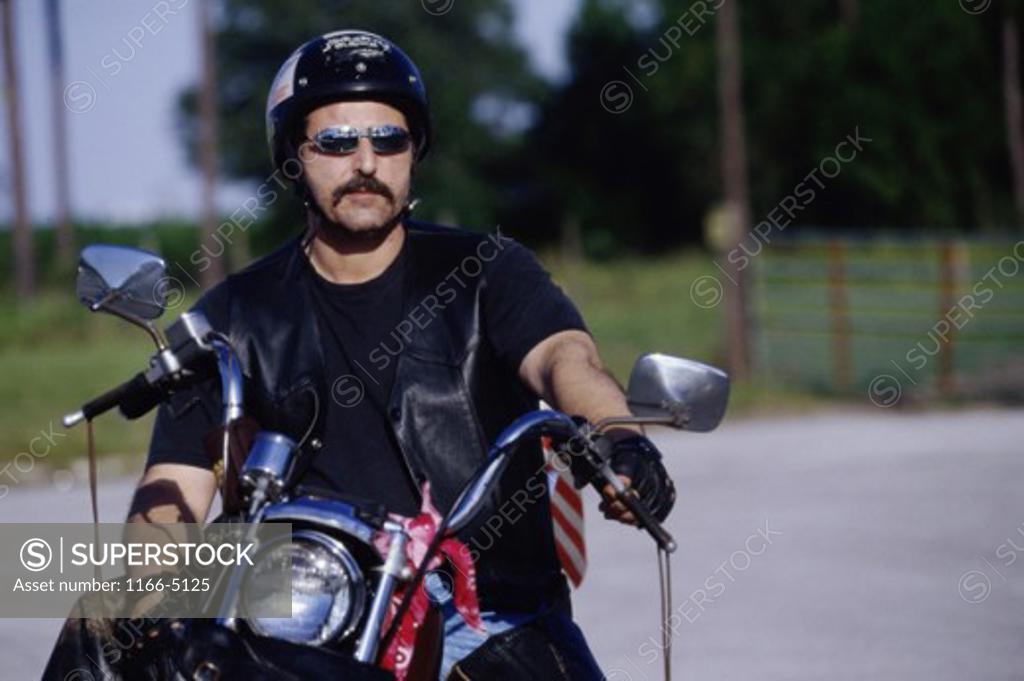 Stock Photo: 1166-5125 Young man on a motorcycle