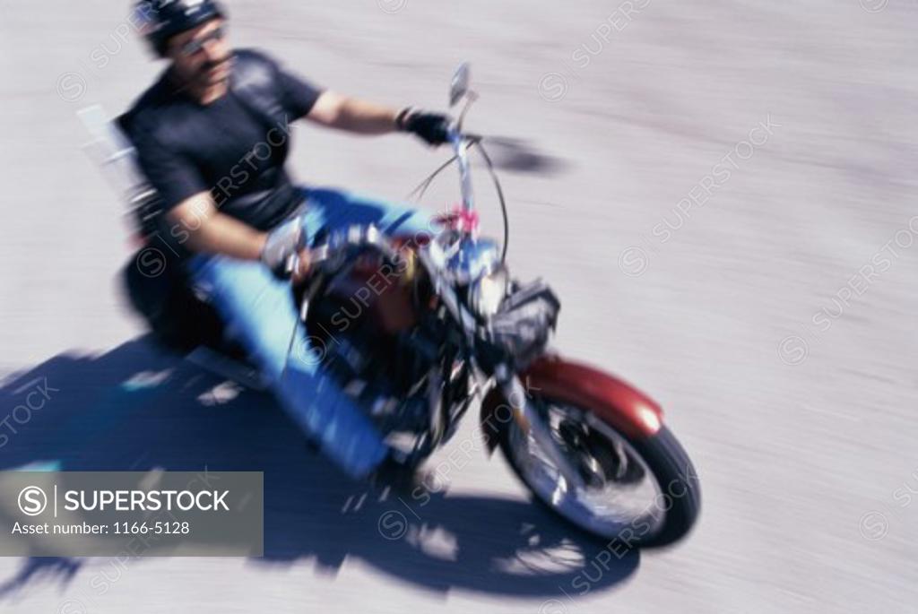 Stock Photo: 1166-5128 High angle view of a young man riding a motorcycle