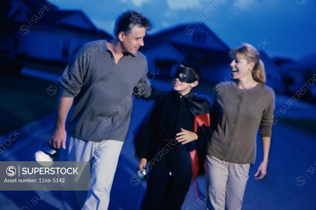 Stock Photo: 1166-5142 Parents trick or treating with their son