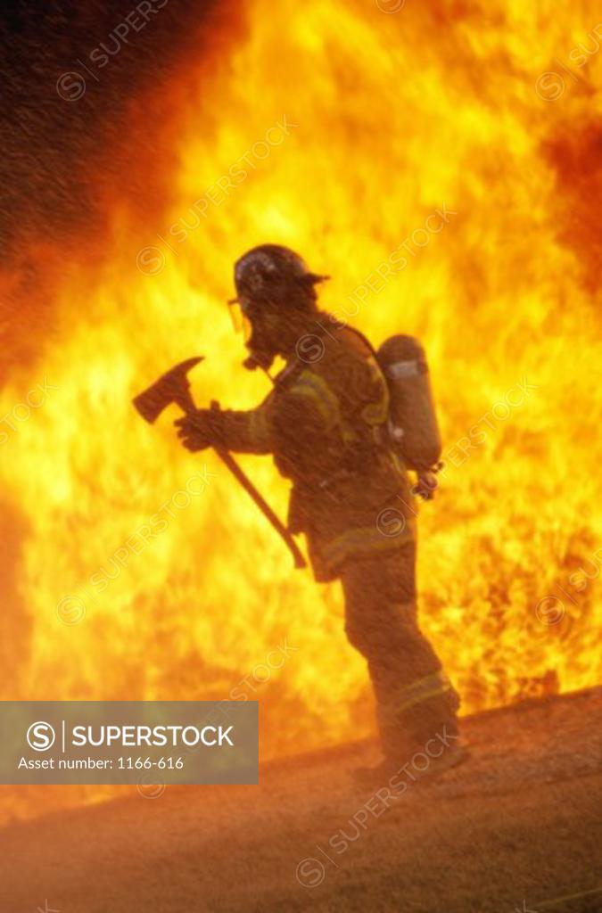 Stock Photo: 1166-616 Side profile of a firefighter holding an axe