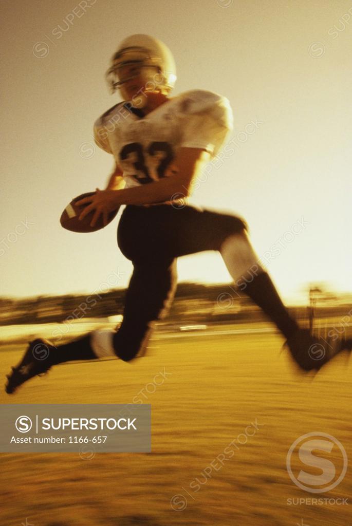 Stock Photo: 1166-657 Football player running with the ball