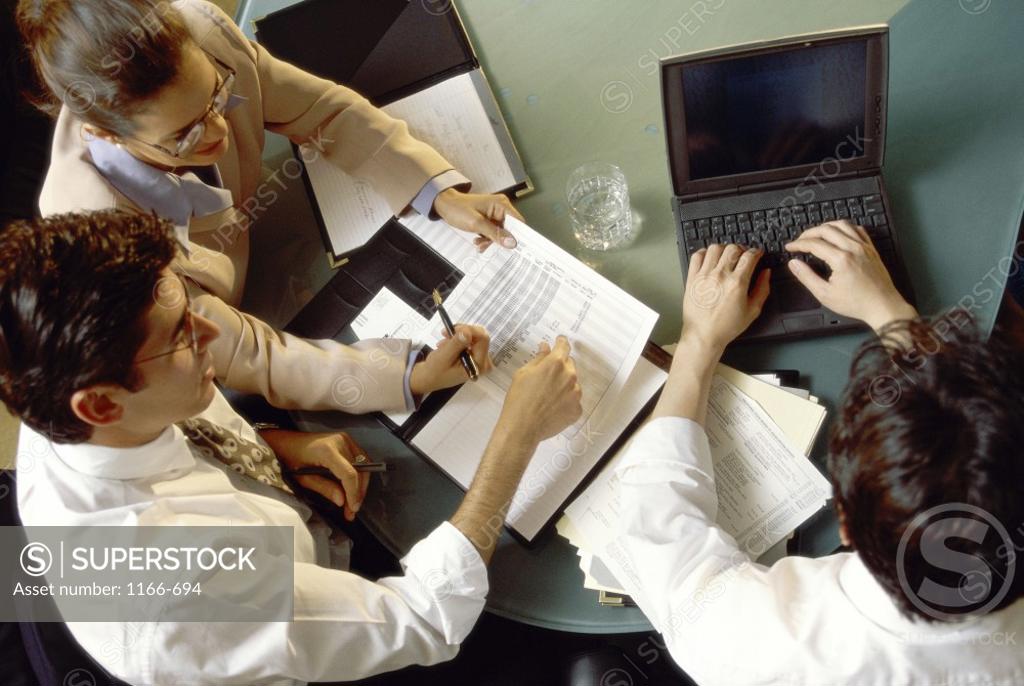 Stock Photo: 1166-694 High angle view of two businessmen and a businesswoman in an office