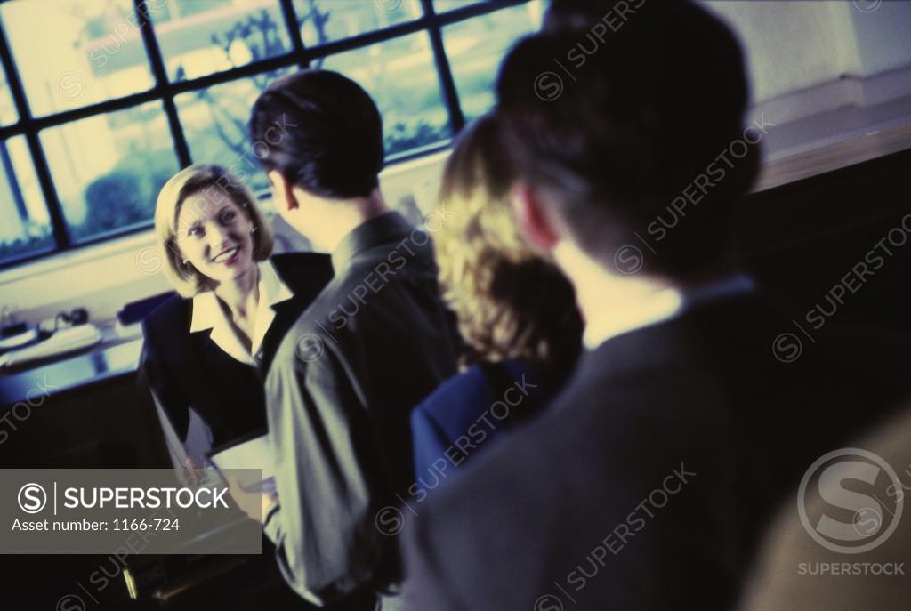 Stock Photo: 1166-724 Rear view of a group of people standing in a row at the bank