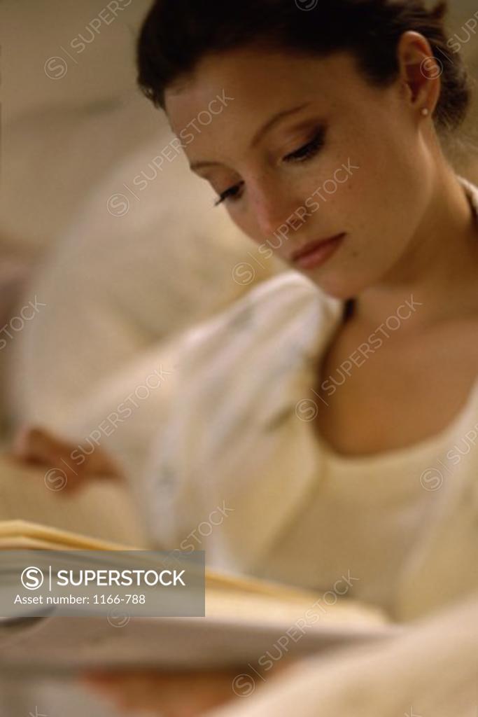 Stock Photo: 1166-788 Close-up of a young woman reading a book