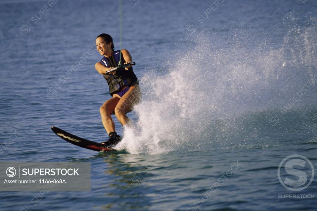 Stock Photo: 1166-868A Young woman waterskiing